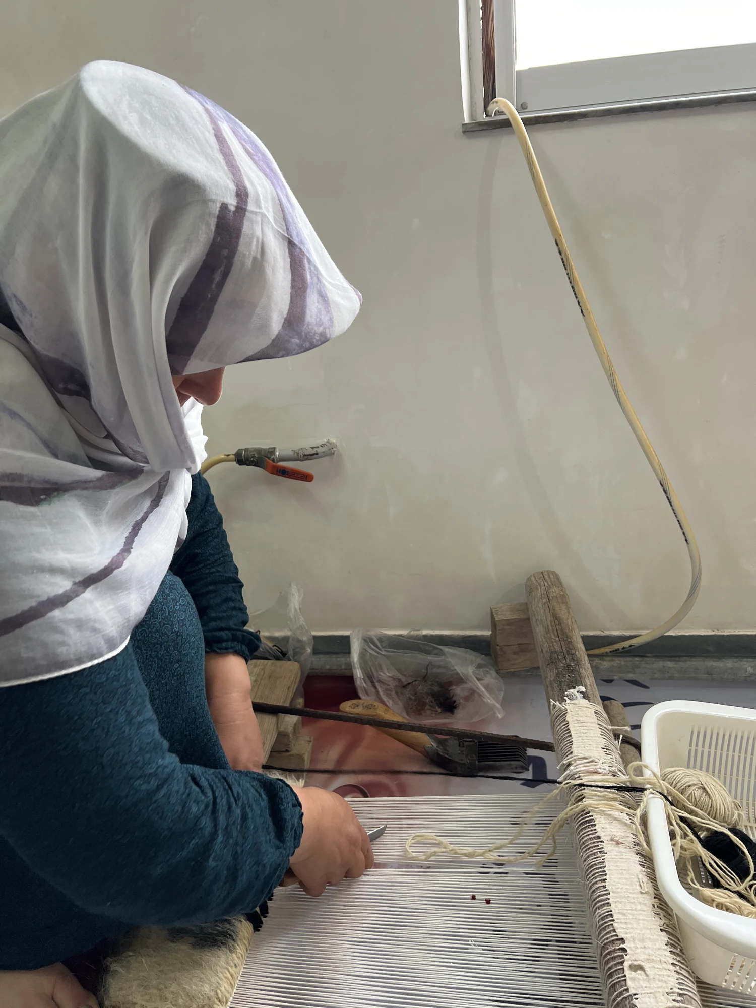 An artisan working beside a loom